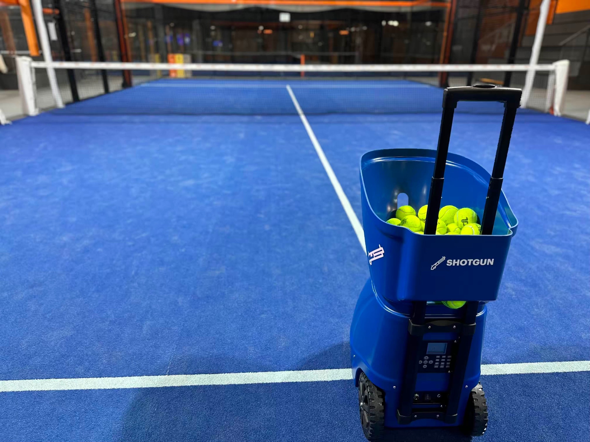 Smart padel ball machine on a court