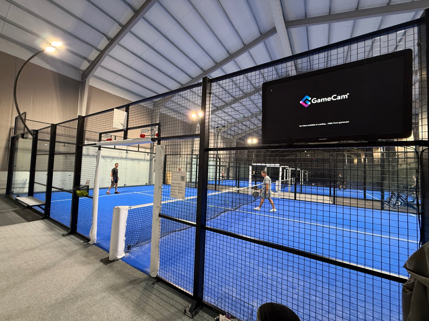 GameCam TV installed courtside at an indoor padel club, looping live courts and highlights